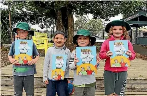  ??  ?? Okaihau Primary School students Devyn Ward, Steven Lewis-Repia, Draedyn Baker and Sian Coleman with the new book.