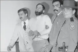  ?? DAVID HANDSCHUH — THE ASSOCIATED PRESS FILE ?? Law officials escort a handcuffed David Gilbert, second from left, from Rockland County Court in New City, N.Y.