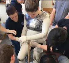  ??  ?? RIGHT: Students creating a fullbody plaster cast of the human form.