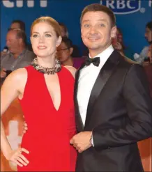  ?? Canadian Press file photo ?? Amy Adams, left, and Jeremy Renner pose as they promote their movie Arrival at theToronto Internatio­nal Film Festival in September 2016.The film is up for eight Oscars tonight.