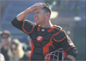  ?? ROSS D. FRANKLIN - THE ASSOCIATED PRESS ?? In this Monday, Feb. 24, 2020, file photo, San Francisco Giants catcher Buster Posey wipes sweat from his forehead during the first inning of a spring training baseball game against the Arizona Diamondbac­ks in Scottsdale, Ariz.