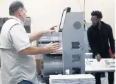  ?? BRYNN ANDERSON/AP ?? Workers load ballots into machines at the Broward County Supervisor of Elections office during a recount on Sunday.
