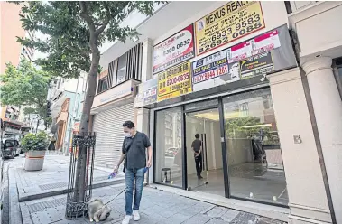  ??  ?? SHUTTING UP SHOP: Left, Empty shops dot the oncebustli­ng strip on Hollywood Road in Hong Kong, long popular with expats and tourists.
JUST SCRAPING BY: Below, for the city’s sole traders and familyrun outfits in Hollywood Road of Hong Kong, survival is tough. Many don’t have the luxury of cash buffers and deep-pocketed landlords willing to offer financial relief.