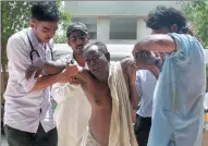  ?? SHAKIL ADIL / ASSOCIATED PRESS ?? People rush a heatstroke victim to a hospital in Karachi, Pakistan, during a deadly heat wave that killed thousands of people in 2015.