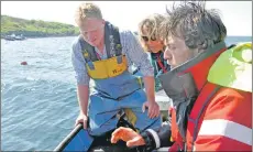  ??  ?? Scallop diver Douglas Chirnside, left, Lottie Goodlet and SAMS researcher Dr Adrian MacLeod.
