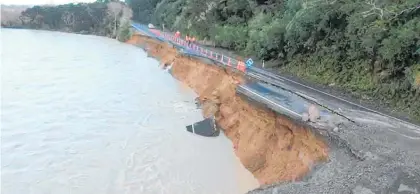  ?? Photo / NZME ?? A section of State Highway 35 near Te Kaha collapsed into the Motu River.