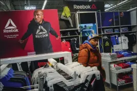  ?? EDUARDO MUNOZ ALVAREZ — THE ASSOCIATED PRESS ?? A man walks past a Reebok display at the Walmart Supercente­r in North Bergen, N.J., on Feb. 9.