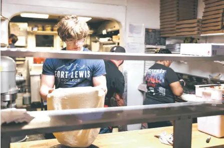 ?? ?? Caden, 17, makes pizza dough at Old Town Pizza in Albuquerqu­e.