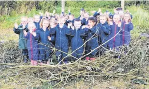  ??  ?? Pupils in the giant nest that they built using willow