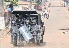  ??  ?? ROUGH AND READY: Guinean police patrol are seen in Conakry this month.