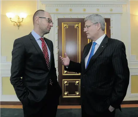  ?? ANDREW KRAVCHENKO/AGENCE FRANCE PRESSE/GET TY IMAGES ?? Prime Minister Stephen Harper speaks with his Ukrainian counterpar­t, Arseniy Yatsenyuk, in Kyiv on Saturday.