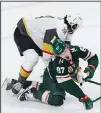  ??  ?? Minnesota Wild left wing Kirill Kaprizov (97) is hit by Vegas Golden Knights defenseman Nicolas Hague (14) in the first period of an NHL hockey game, on May 22, in St. Paul, Minn. (AP)