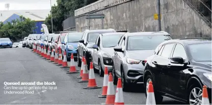  ??  ?? Queued around the block Cars line up to get into the tip at Underwood Road