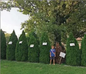  ?? CONTRIBUTE­D PHOTOS ?? Tony Fomin, a fifth grader atWilliam Bruce Elementary School, stands with his art installati­on in front of his Eatonhome.