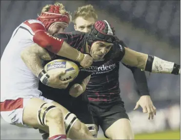  ?? Picture: SNS ?? Netani talei of Edinburgh is tackled by ulster’s Johann Muller as he charges forward