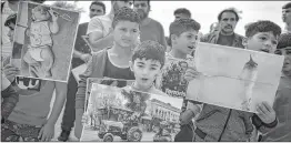  ?? PIC: AFP ?? Children hold pictures, as Syrian Kurd refugees protest at the Ritsona camp on October 10, 2019.