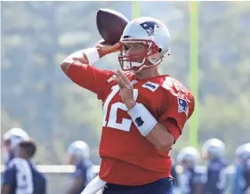  ??  ?? Patriots quarterbac­k Tom Brady throws during practice Friday in Foxborough, Mass. CHARLES KRUPA/AP