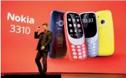  ??  ?? Arto Nummela, CEO ofnokia-hmd, holds up anokia3310 device during a presentati­on at Mobile World Congress in Barcelona