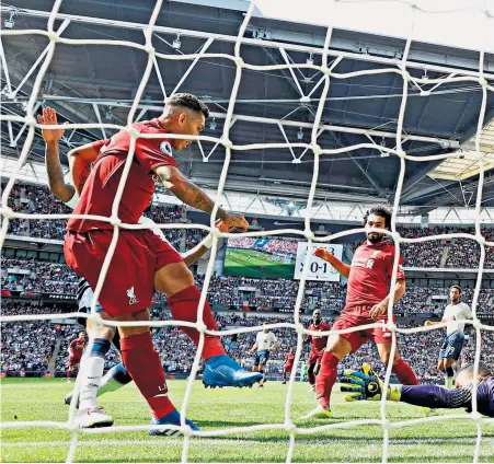  ??  ?? Tap-in: Roberto Firmino beats Michel Vorm for Liverpool’s second goal