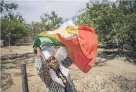  ??  ?? FLAG BEARER. Firekey Tafari I waves the green, yellow and red Rastafaria­n flag.