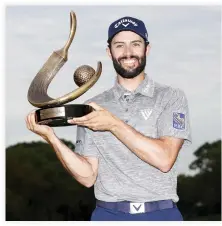  ??  ?? Adam Hadwin holds the trophy after winning the Valspar Championsh­ip during the final round at Innisbrook Resort Copperhead Course in Palm Harbor, Florida, on Sunday. (AFP)