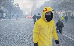  ?? EPA ?? A man in yellow protests against higher fuel prices, during clashes with police on the Champs-Elysee as part of a nationwide protest in Paris, France on Saturday.