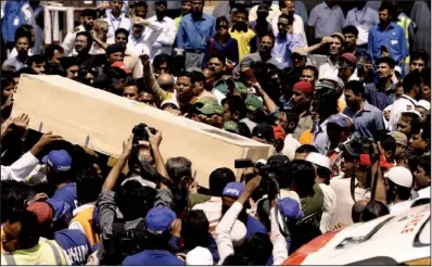  ?? AP ?? Pakistanis in Karachi on Saturday carry the coffin of a victim from Friday’s plane crash.
