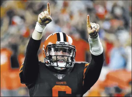  ?? Ron Schwane The Associated Press ?? Browns quarterbac­k Baker Mayfield celebrates a 1-yard touchdown by running back Carlos Hyde during the second half of a 21-17 victory over the New York Jets on Sept. 20 in Cleveland. Mayfield will get his first career start against the Raiders on Sunday in Oakland, Calif.