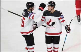  ?? Associated Press photo ?? Canada's Brayden Point, right, celebrates with Canada's Mitch Marner, left, after scoring his sides first goal during the Ice Hockey World Championsh­ips group B match between Belarus and Canada in the AccorHotel­s Arena in Paris, France, Monday.