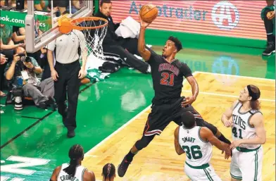  ?? MADDIE MEYER / GETTY IMAGES / AFP ?? Jimmy Butler of the Chicago Bulls goes up for a shot against the Boston Celtics during the third quarter of Sunday’s opening game of their Eastern Conference quarterfin­al at TD Garden in Boston. The Bulls won 106-102.