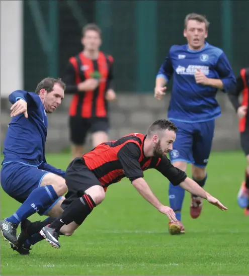  ??  ?? Austin McCann of Boyne Harps and Declan Sharkey of Bellurgan United compete for possession. Pictures: Ken Finegan