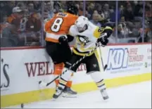  ?? MATT SLOCUM — THE ASSOCIATED PRESS ?? The Penguins’ Phil Kessel and the Flyers’ Robert Hagg collide during the third period of Monday night’s game in Philadelph­ia. Pittsburgh won 4-1.