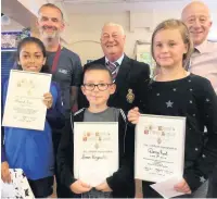  ??  ?? Amarah Price, Darcy Kent and Simon Kingsworth receiving their prizes at Great Harwood Primary School