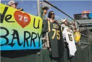  ?? Michael Macor / The Chronicle ?? Fans at the Oakland Coliseum show their support for pitchers Barry Zito and Tim Hudson.