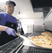  ?? ?? A staff member prepares pizzas at a Domino’s Pizza restaurant in Moscow, Russia, July 14, 2017.