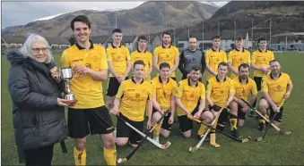  ?? Photograph: Iain Ferguson, alba.photos ?? Sheila Ferguson presents the Cup in memory of her son Drew to Fort William captain Arran MacPhee. The match is played annually between Fort William and Kyles, this being the first time Drew’s former team has won it.