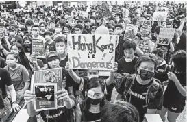  ?? ANTHONY KWAN/GETTY ?? Protesters occupy the arrival hall of the Hong Kong Internatio­nal Airport during a demonstrat­ion on Monday. China issued warnings that described the protests as “terrorism.”