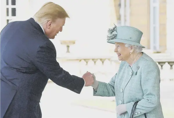  ??  ?? 0 US president Donald Trump appears to greet the Queen with a fist bump as he arrives at Buckingham Palace yesterday to start his three-day UK visit