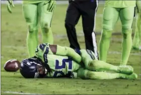  ?? RICK SCUTERI — THE ASSOCIATED PRESS ?? Seattle Seahawks cornerback Richard Sherman (25) lies injured on the turf after tackling Arizona Cardinals wide receiver John Brown (12) during the second half of an NFL football game, Thursday in Glendale, Ariz. Sherman did not return to the game...