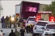  ?? AP FILE ?? Police and other first responders work the scene where officials say dozens of people have been found dead and multiple others were taken to hospitals with heat-related illnesses after a semitraile­r containing suspected migrants was found, on Monday in San Antonio.