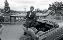 ?? GETTY IMAGES ?? British actor Roger Moore on set of the James Bond movie ‘A View to a Kill’ with half a car during filming in Paris, France in August 1984.