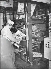  ?? THE DAY ?? A pressroom operator checks an edition of The Day on Nov. 4, 1976. Google and Facebook, both rich, highly successful companies, have been brutal to the news industry.