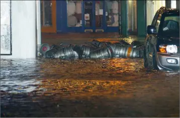  ??  ?? Beer kegs float down the street during flooding at Selskar in 2004.