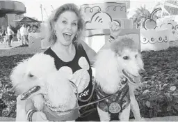  ?? FACEBOOK ?? Susan Grill with two of her service dogs in a photo posted to her Facebook in 2017. Grill sued Walt Disney World for discrimina­tion and retaliatio­n in federal court.