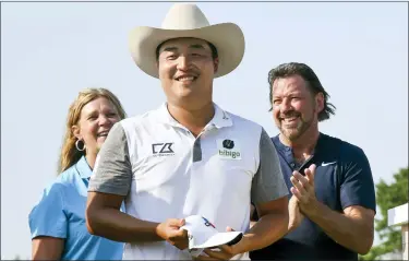  ?? EMIL LIPPE — THE ASSOCIATED PRESS ?? K.H. Lee smiles after donning a custom-made cowboy hat after winning the Byron Nelson Sunday in Mckinney, Texas.