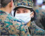  ??  ?? Pfc. Emily Sandoval is awarded her Eagle, Globe and Anchor pin and the title of U.S. Marine from her drill instructor on Thursday.