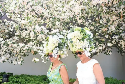  ?? PHOTOS: TRACEY NEARMY/AAP AND AP ?? In a case of who wore it better, women in floral headpieces walk past cherry blossoms at the Flemington Racecourse in Melbourne and, right, model Jean Shrimpton in her scandalous 1965 Ladies' Day outfit without gloves or stockings.