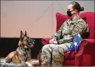  ?? U.S. AIR FORCE PHOTO/R.J. ORIEZ ?? MilitaryWo­rking Dog Rudo and his handler, StaffSgt. Lacey Bockman of the 88th Security Forces Squadron, are pictured at his retirement ceremonyNo­v. 16 in the Wright-Patterson Air Force Base theater. Rudo’s retirement plans are tomove in with Bockman and her two other dogs.