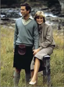  ?? THE ASSOCIATED PRESS ?? Prince Charles and Diana, Princess of Wales pose for photograph­ers during their honeymoon in Balmoral, Scotland, on Aug. 19, 1981.