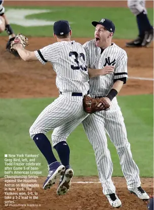  ?? AP Photo/Frank Franklin II ?? New York Yankees' Greg Bird, left, and Todd Frazier celebrate after Game 5 of baseball's American League Championsh­ip Series against the Houston Astros on Wednesday in New York. The Yankees won, 5-0, to take a 3-2 lead in the series.